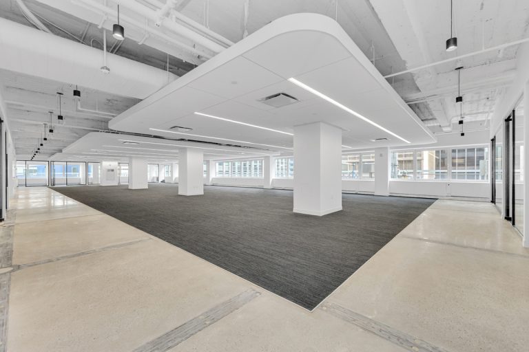 Wide-angle view of empty open-plan office space at 711 Third Avenue, New York
